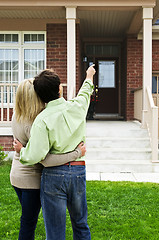 Image showing Happy couple in front of home