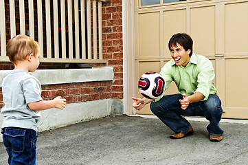 Image showing Father and son playing soccer