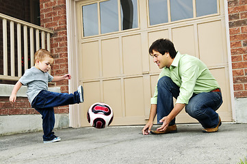 Image showing Father and son playing soccer