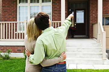 Image showing Happy couple in front of home