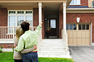 Image showing Happy couple in front of home