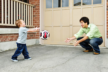 Image showing Father and son playing soccer