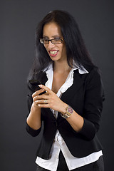 Image showing picture of a businesswoman looking at a phone smiling