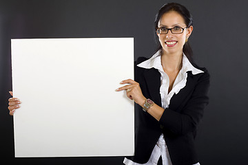 Image showing attractive businesswoman presenting a blank board