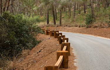 Image showing Road in the forest with wooden guardrail in perspective