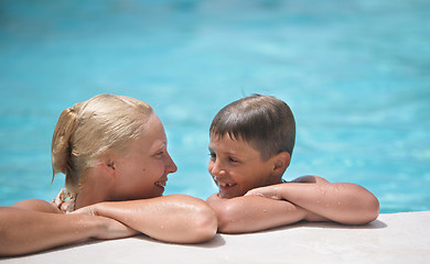 Image showing happy boy and mom in the swimming pool