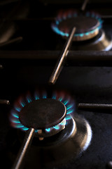 Image showing Lit gas cooker burners