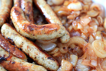 Image showing Fried sausages and onion