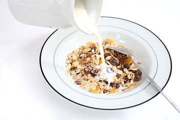 Image showing Pouring milk on muesli