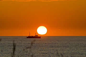 Image showing Sunset with a boat