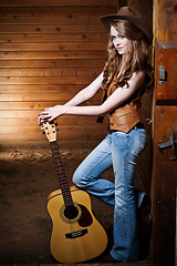 Image showing Beautiful caucasian cowgirl with guitar