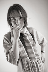 Image showing thoughtful young woman in striped muffler