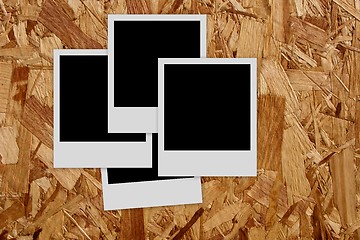 Image showing Pile of  empty photo frames  on wood background