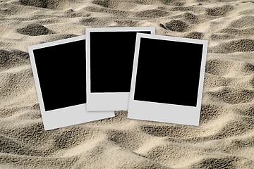 Image showing Empty photo frames  on sand background