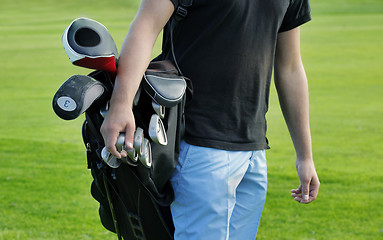 Image showing Male golfer carrying clubs, close-up