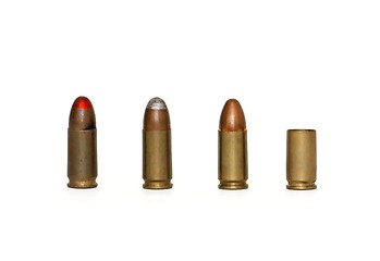 Image showing Row of three 9mm cartridges and spent case isolated 