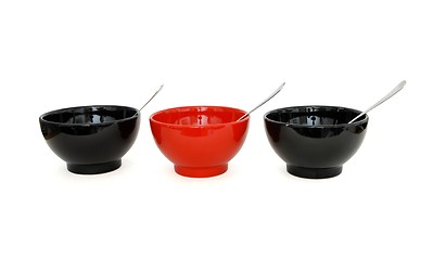 Image showing Row of porcelain bowls with spoons isolated