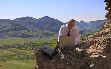 Image showing Businessman on a computer outdoors