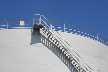 Image showing  Oil reservoir detail with access ladder against a blue sky