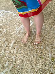 Image showing Female legs on beach