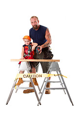 Image showing Father teaching son drilling