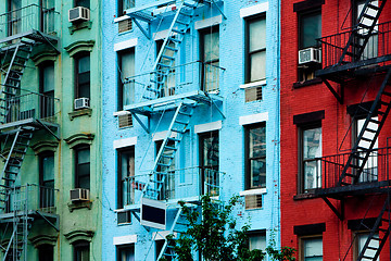 Image showing Colorful apartment buildings with fire escapes