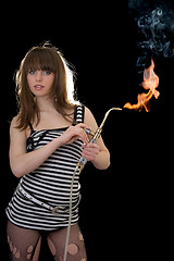 Image showing Pretty young woman with a gas torch