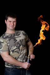 Image showing Strong young man with a gas torch