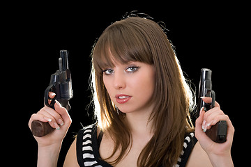 Image showing Attractive young woman with two pistol. Isolated