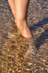 Image showing woman legs in sea water