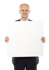 Image showing Businessman holding blank board