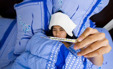 Image showing pretty young woman sick in bed