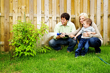 Image showing Family watering plant