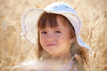 Image showing Lovely girl among wheat ears 