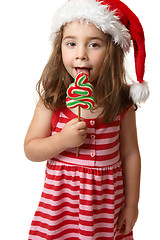 Image showing Santa girl licking Christmas tree lollipop candy