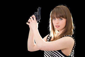 Image showing Beautiful young woman with pistol. Isolated on black