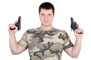 Image showing Young man with a two pistol. Isolated