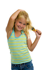 Image showing cute blond girl brushing her hair