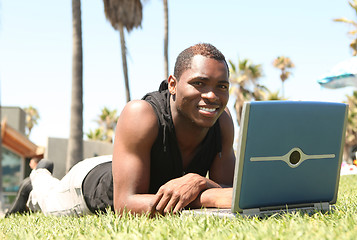 Image showing African Amercian Man Working on a Laptop