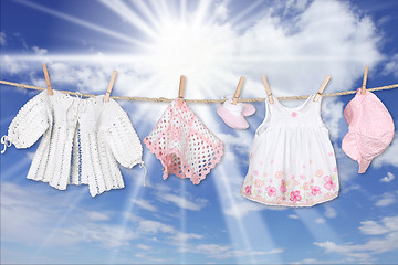 Image showing Baby Girl Clothing Hanging on a Clothesline Outdoors