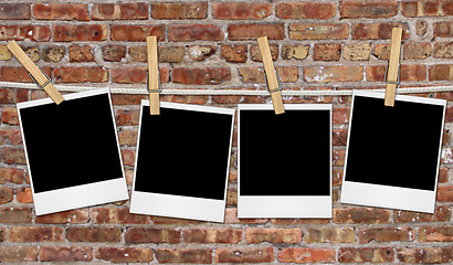 Image showing Empty Film Blanks Hanging Against a Grungy Brick Wall