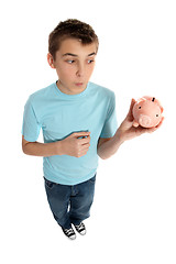 Image showing Boy looking at money box