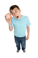 Image showing Surprised boy shaking money box