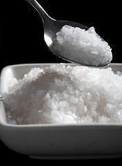 Image showing Salt bowl and spoon on black