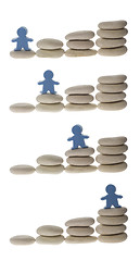 Image showing Series of figurine on stack of pebbles