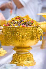 Image showing Dried flower petals in a golden bowl