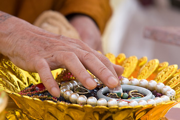 Image showing Hand of Buddhist monk painting religious symbols