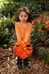 Image showing Girll with a bunch of clivia from the garden