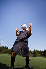 Image showing Hispanic soccer or football player with soccer ball