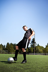 Image showing Hispanic soccer or football player kicking a ball